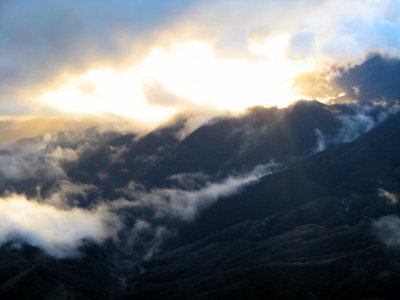 1879 Clouds caressing hills at sunset